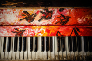 piano with birds painted on it