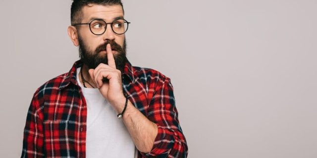 man showing silence symbol